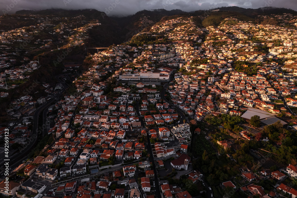 Fototapeta premium Landscape of city in mountains in evening