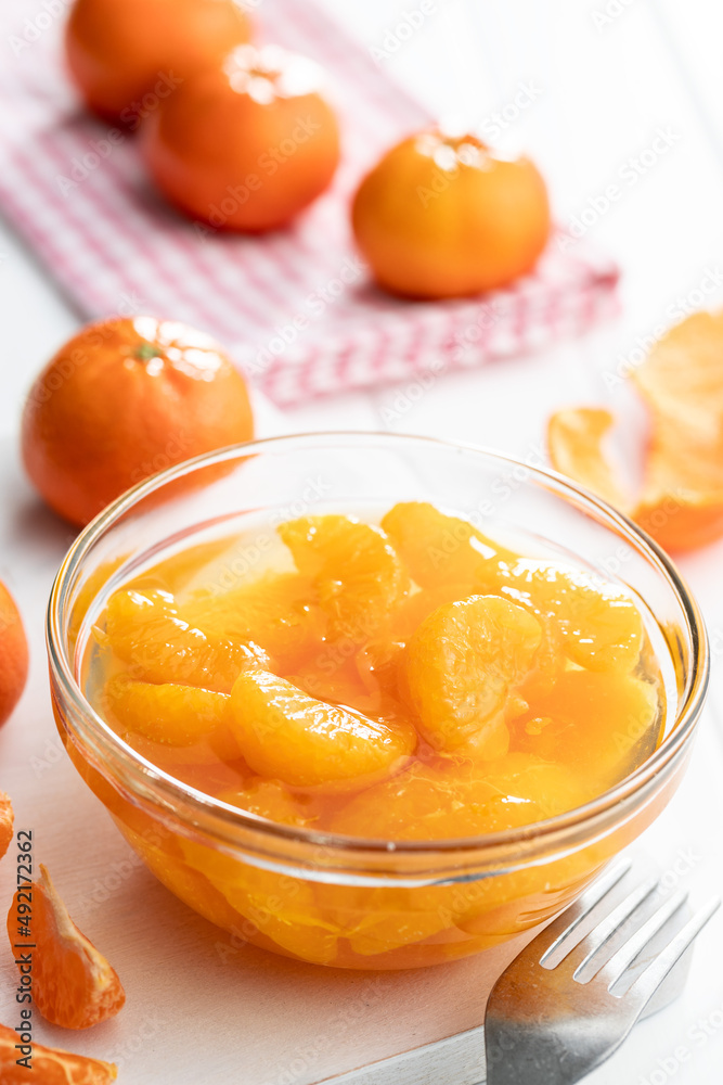 Canned tangerine. Pickled mandarin fruit in bowl on white table. Canned tangerine. Pickled mandarin fruit in bowl on white table.