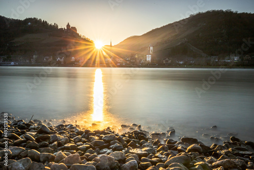 view across the Rhine to Bacharach, historic small town in Germany, Mainz Bingen. Castle, church and vineyards. Sunset photo