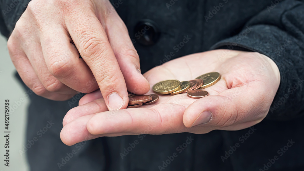 A few coins in men's hands, selective focus. A few coins in men's hands, selective focus.