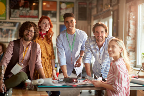 Group of young happy engineers projecting together