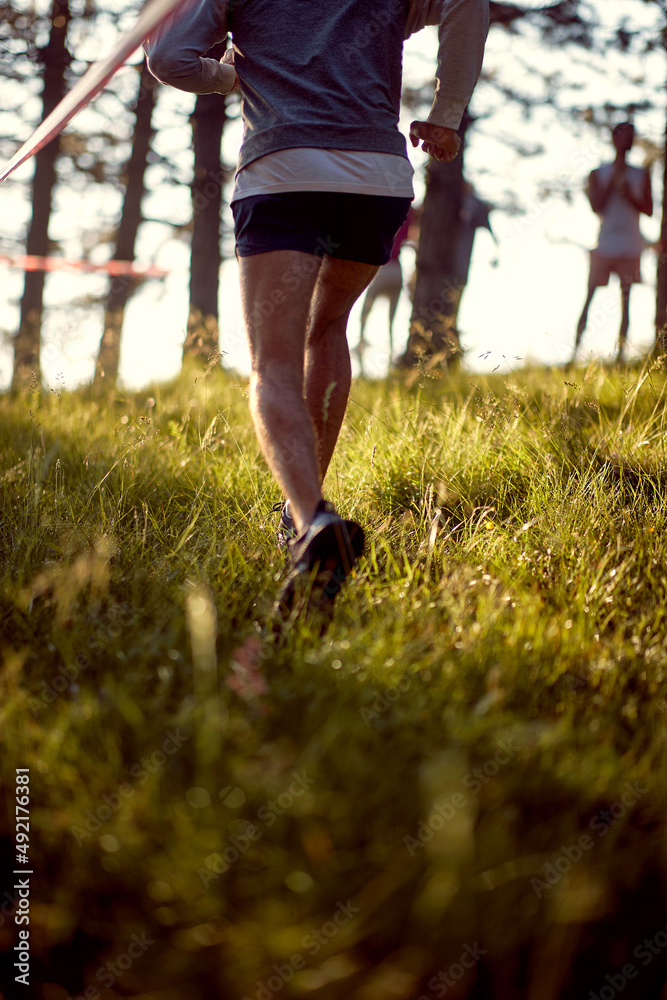 Man running fast through the forest on trail marathon run Man running fast through the forest on trail marathon run