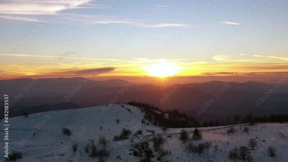 Aerial view at the mountain on a sunset of the winter day