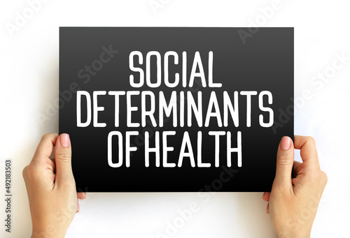 Social determinants of health - economic and social conditions that influence individual and group differences in health status, text on card