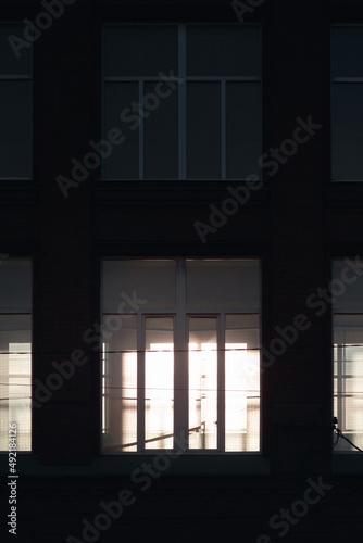 A light passing through a window in the dark foreground