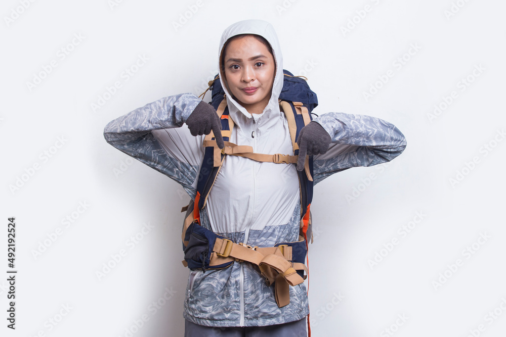 Young asian hiker woman with backpack pointing finger on empty space on white background
Young asian hiker woman with backpack pointing finger on empty space on white background