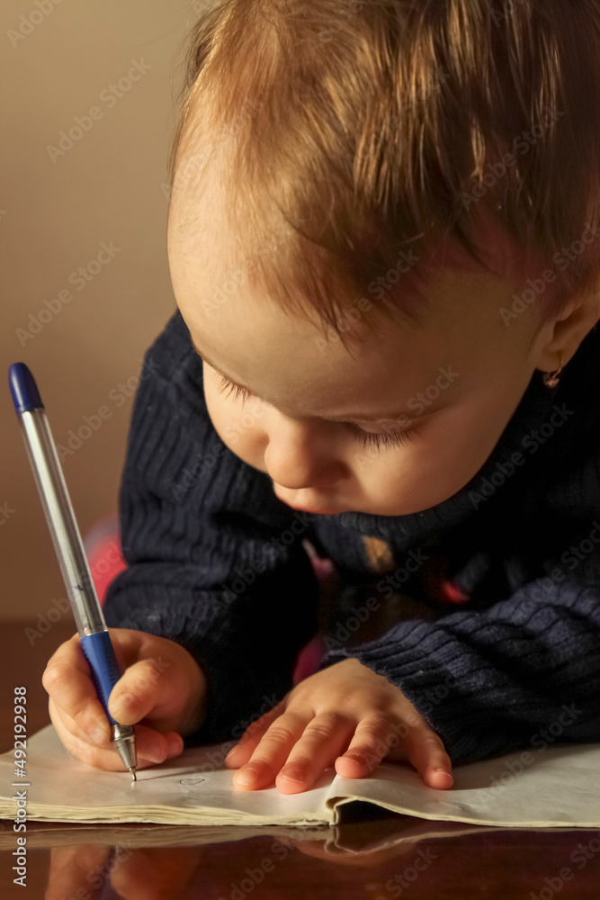 Little beautiful child girl writing latter. Education, knowledge, work, success concept. Vertical image. Little beautiful child girl writing latter. Education, knowledge, work, success concept. Vertical image.