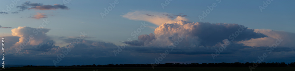Storm clouds cover the landscape. Tragic gloomy sky. Panorama. Landscape at sunset. The sun is hidden. Storm clouds cover the landscape. Tragic gloomy sky. Panorama. Landscape at sunset. The sun is hidden.