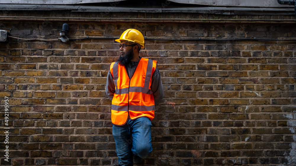 Portrait of an Asian construction worker wearing hard hat and high visibility vest. Portrait of an Asian construction worker wearing hard hat and high visibility vest.