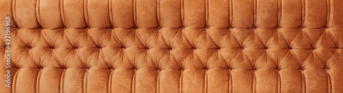 Close up of a sofa background. Spotted furniture texture.