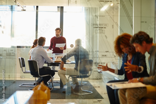 This is not a challenge, its an opportunity. Shot of a group of architects having a meeting in their boardroom.