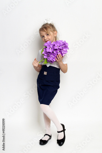 little girl posing with purple lilac flower