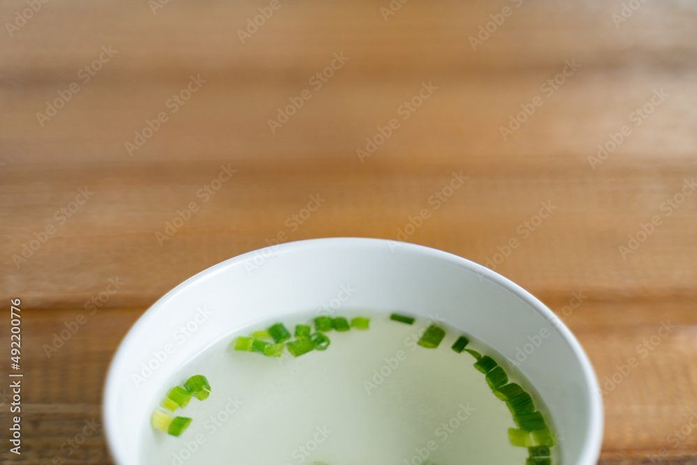 Small bowl of clear soup and vegetable Small bowl of clear soup and vegetable