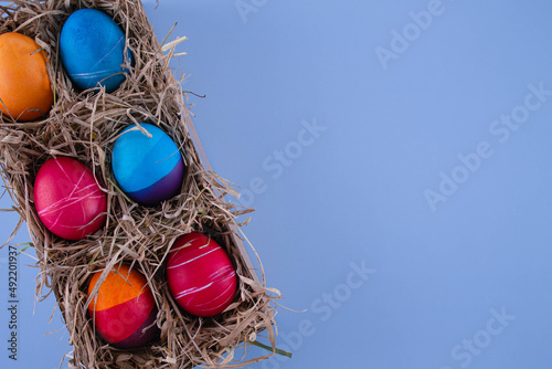 Easter eggs. Festive decoration. Easter. Celebration. Bright holiday. Eggs on a blue background. Multi-colored eggs on an orange background.