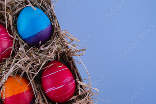 Easter eggs. Festive decoration. Easter. Celebration. Bright holiday. Eggs on a blue background. Multi-colored eggs on an orange background.