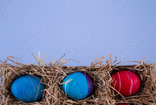 Easter eggs. Festive decoration. Easter. Celebration. Bright holiday. Eggs on a blue background. Multi-colored eggs on an orange background.