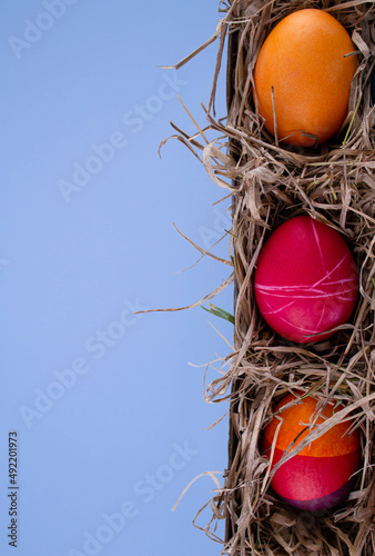 Easter eggs. Festive decoration. Easter. Celebration. Bright holiday. Eggs on a blue background. Multi-colored eggs on an orange background.