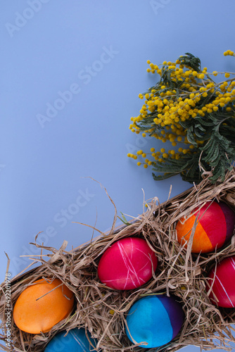 Easter eggs. Festive decoration. Easter. Celebration. Bright holiday. Eggs on a blue background. Multi-colored eggs on an orange background.