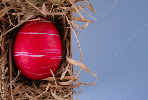 Easter eggs. Festive decoration. Easter. Celebration. Bright holiday. Eggs on a blue background. Multi-colored eggs on an orange background.