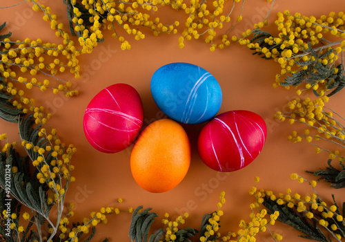 Easter eggs. Festive decoration. Easter. Celebration. Bright holiday. Eggs on an orange background. Multi-colored eggs on an orange background.