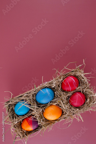 Easter eggs. Festive decoration. Easter. Celebration. Bright holiday. Eggs on a red background. Multi-colored eggs on a red background.