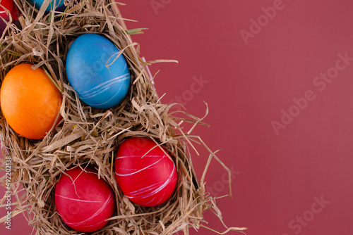 Easter eggs. Festive decoration. Easter. Celebration. Bright holiday. Eggs on a red background. Multi-colored eggs on a red background.