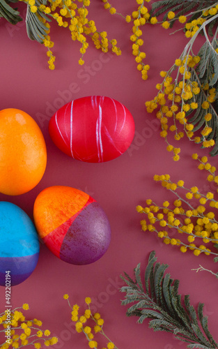 Easter eggs. Festive decoration. Easter. Celebration. Bright holiday. Eggs on a red background. Multi-colored eggs on a red background.