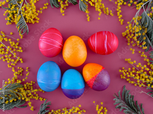 Easter eggs. Festive decoration. Easter. Celebration. Bright holiday. Eggs on a red background. Multi-colored eggs on a red background.
