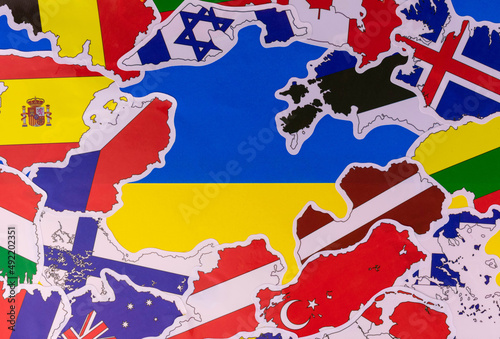 The flag of Ukraine in the center and many flags of other countries supporting Ukraine in defense against the Russian attack.