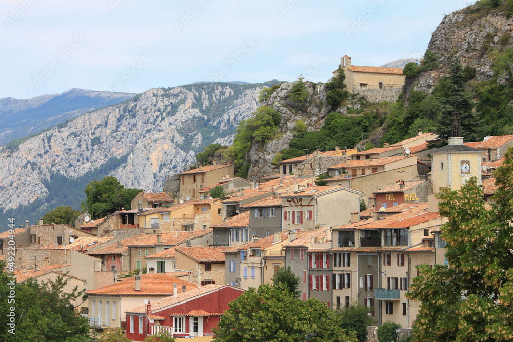 View to the hillside houses and roofs of the french village Aiguines, Provence, France with the regional national park Verdon, canyon Gorge du Verdon in blurred background