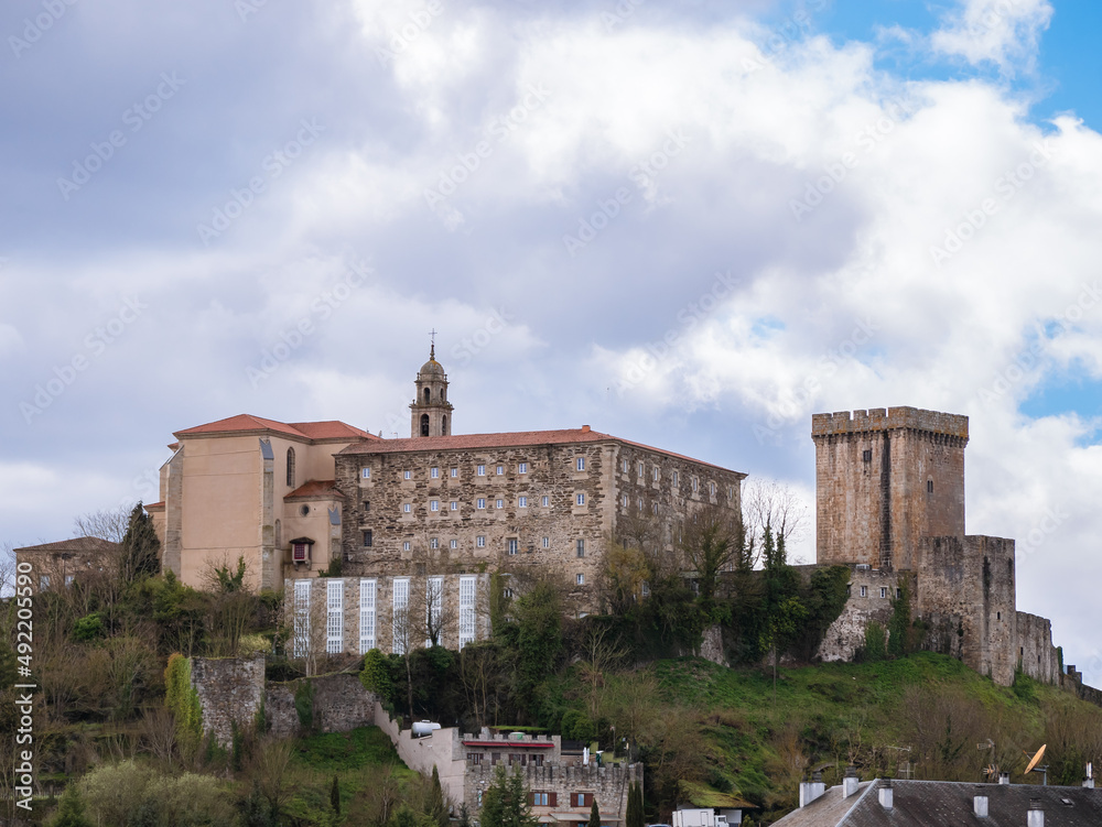 Castle of Monforte de Lemos, located on a small hill in the Monforte valley. View of the wall, the homage tower, the Count's Palace and the Benedictine Monastery. cloudy day cong large cumulus clouds