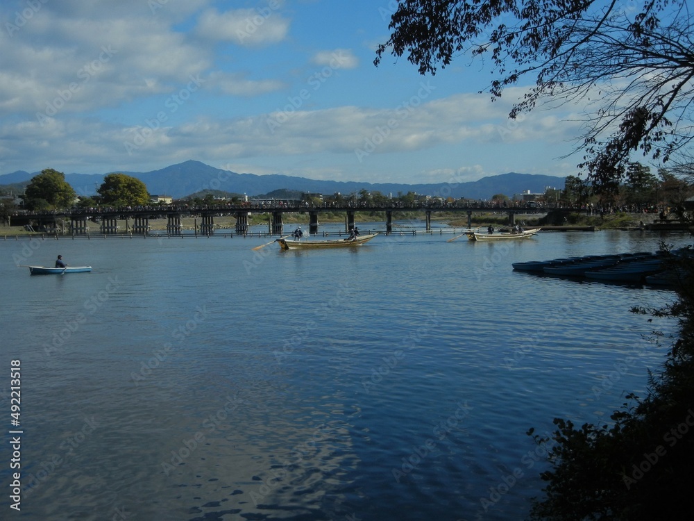 Excursion boats and Togetsu-kyo Bridge and Hozu-gawa River at Arashiyama in Kyoto City in Japan 日本の京都市嵐山の遊覧舟と保津川と渡月橋