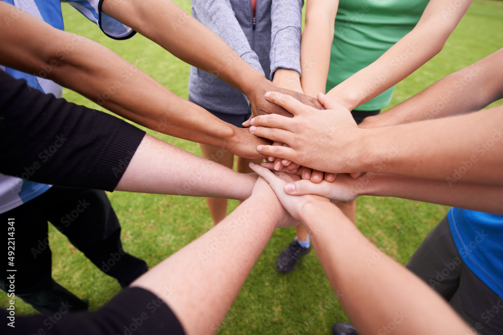 On three. Cropped shot of a sports team with their hands in a huddle. On three. Cropped shot of a sports team with their hands in a huddle.