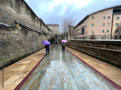 Heavy rain, with homeward bound shoppers, in the post industrial city of, Bradford, Yorkshire, UK