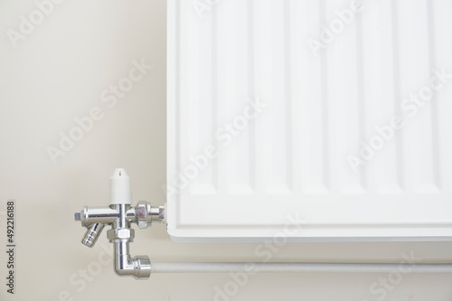 New white radiator white on pale wall house interior