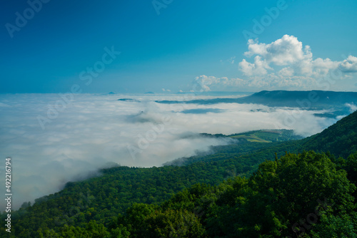 Germany, Magical panorama view above endless sea of fog clouds in valley of swabian alb mountains nature landscape on sunny day