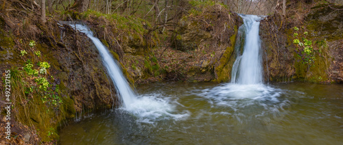 small waterfall on mountain river fall into pool