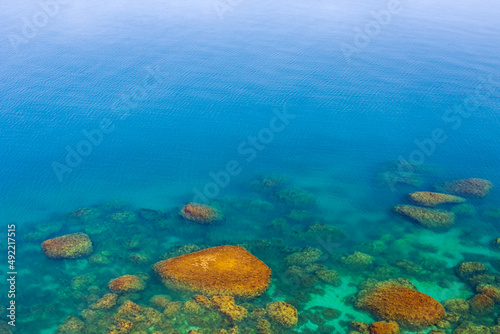 emerald sea bay with stony coast