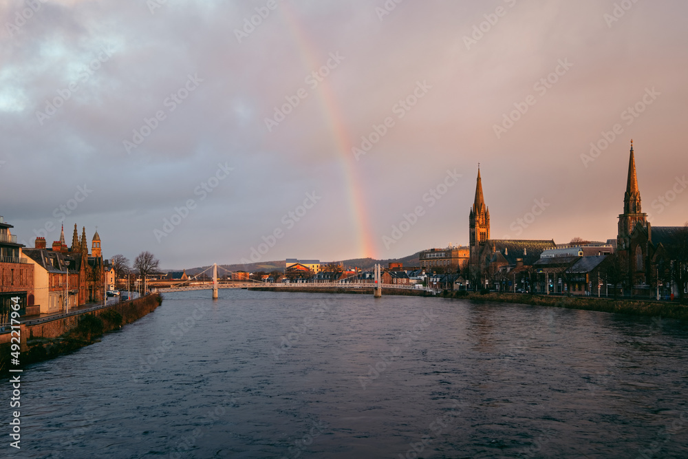 Fototapeta premium Beautiful cityscape of morning city and river with rainbow. River Ness, Inverness, Scotland