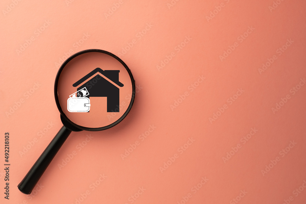 Home Insurance,Saving Money For House,Real Estate loan Concept.,Magnifying glass with house and money bag icon over pink pastel background with copyspace for put your text or logo. Home Insurance,Saving Money For House,Real Estate loan Concept.,Magnifying glass with house and money bag icon over pink pastel background with copyspace for put your text or logo.