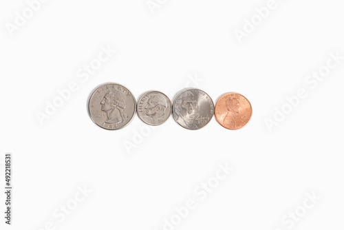 A series of American coins in a row, "heads" side up, in order from greatest to least in monetary value.