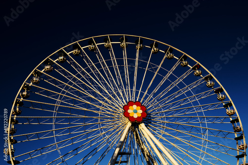 Large ferris wheel with flower decoration in Prater amusement park in Vienna  Austria  Europe - blue sky background