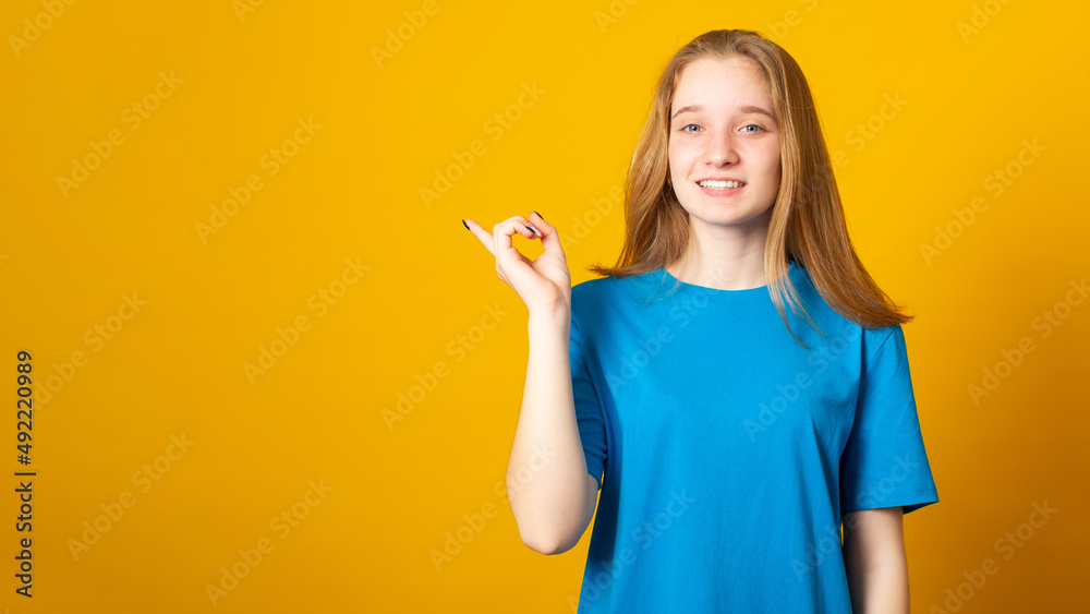 Positively surprised woman points upwards with broad smile, recommends awesome product, suggests click banner, shows advertisement promo. Positively surprised woman points upwards with broad smile, recommends awesome product, suggests click banner, shows advertisement promo.