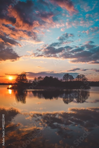 Beautiful morning spring landscape. Sunrise over the lake with a beautiful sky.