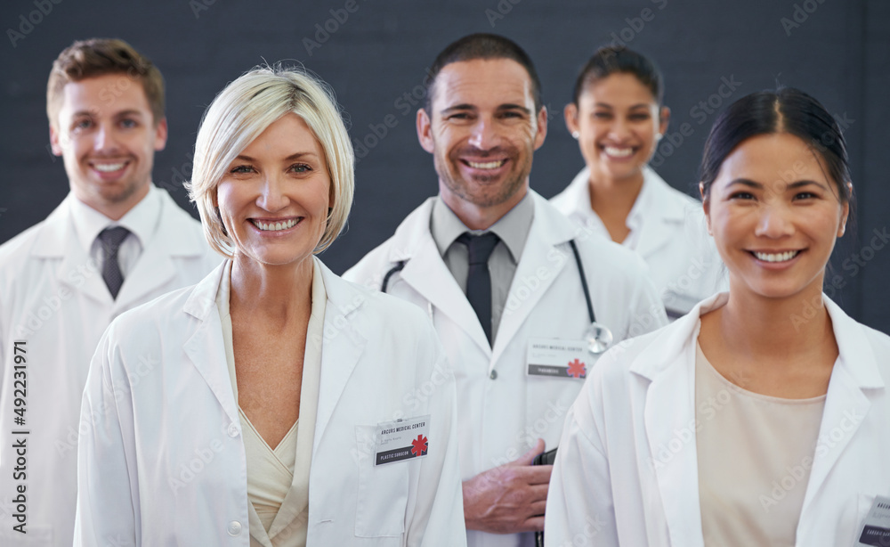 Medicines finest. Studio portrait of a team of doctors standing against a grey background. Medicines finest. Studio portrait of a team of doctors standing against a grey background.