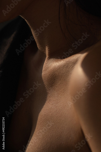 Bare neck, shoulders and collarbones of a beautiful woman. Beauty and details of the female body. Youth concept. photo