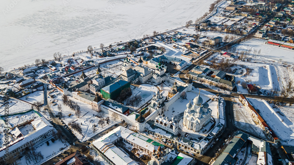 Fototapeta premium The ancient monastery behind the fortress wall. Beautiful churches with domes. Old Russian architecture. Winter day.