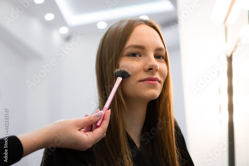 Portrait of beautiful woman getting cosmetic care at beauty salon