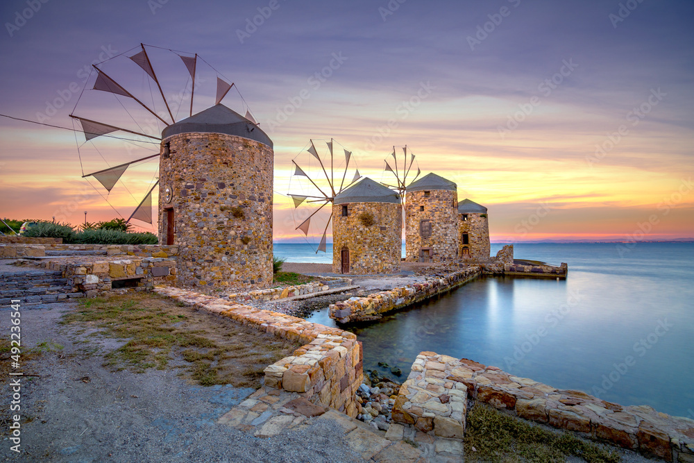 Old windmills by the beach, Chios island, Greece.