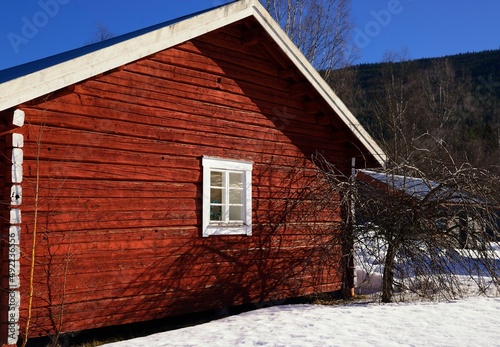 Small red Swedish cottage in winter © a40757se